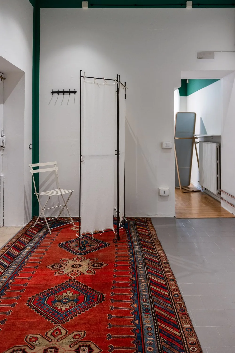 Il camerino con paravento e il passaggio verso il magazzino